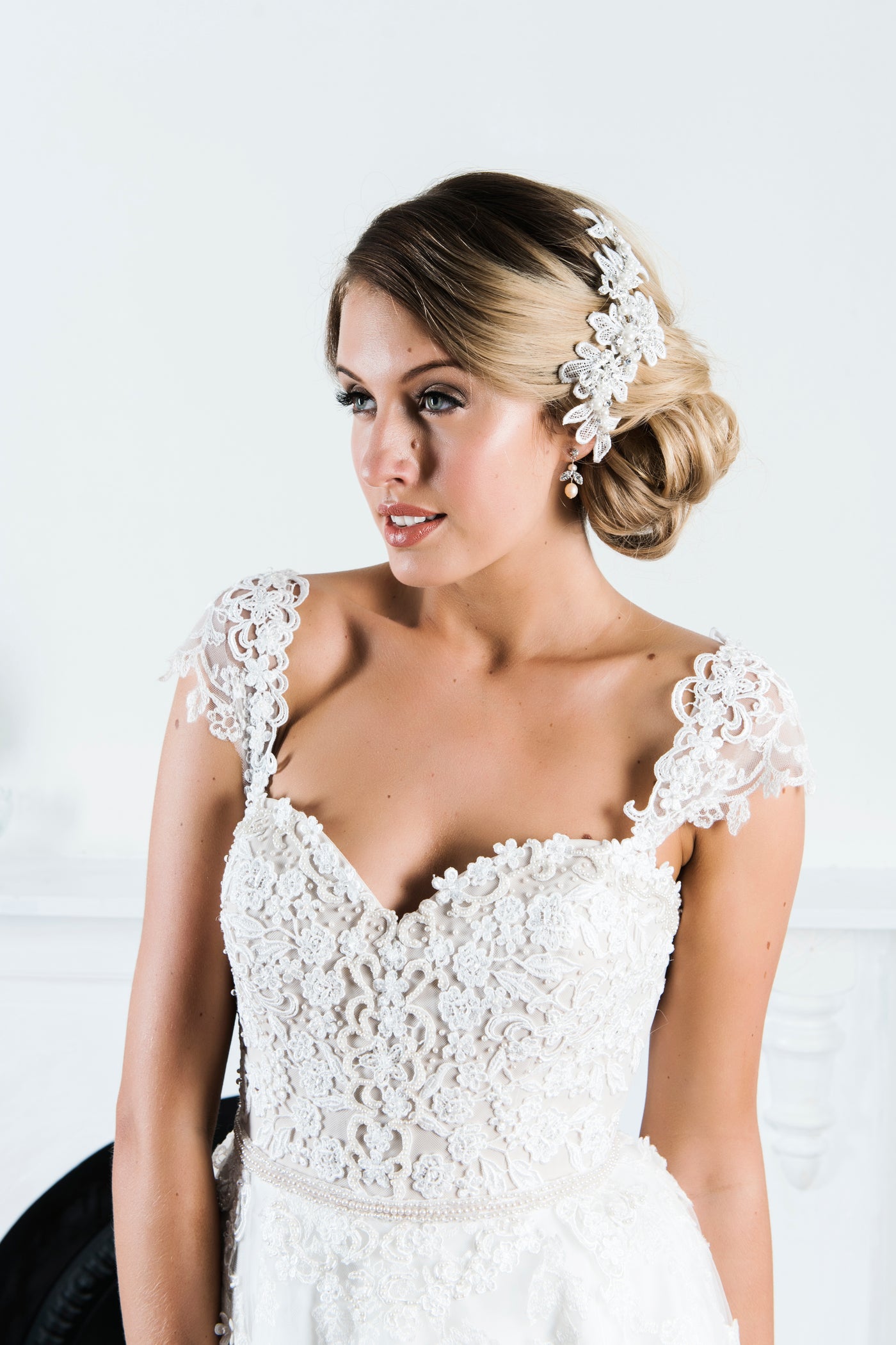 Ivory wedding gown with pearl adorned lace bodice and cap sleeves